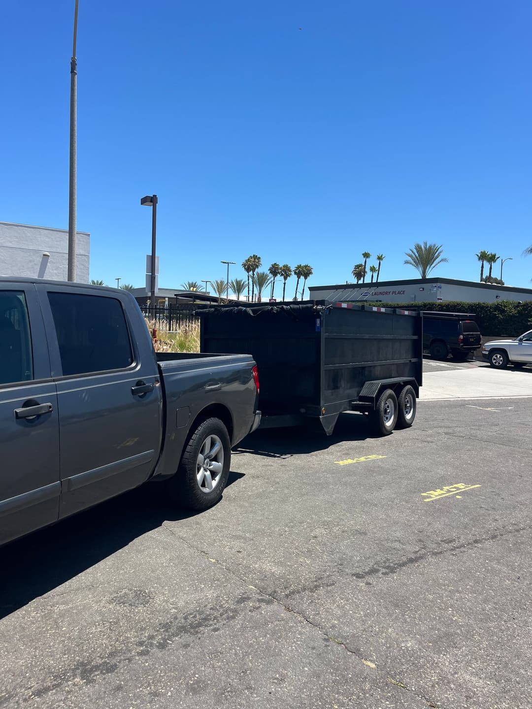 picture of a truck and dumpster owned by M Junk Removal and Escondido Junk Removal